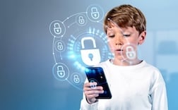 Child school boy with smartphone, digital cybersecurity hologram with glowing lock circuit\. Cybersecurity hud and connection\. Concept of data protection